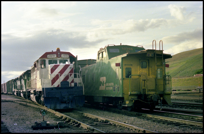 BN XW with lead locomotive BN 1976, painted in Freedom locomotive color scheme passing a east bound train west of Missoula.