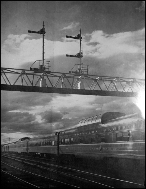 NP Train No. 25  with Vista Domes and coach passing under signal bridge at DeSmet, MT