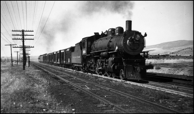 NP 2213, a 4-6-2 Pacific Class Q-4 pulling a mixed passenger train No. 256 and freight train at DeSmet, Montana.