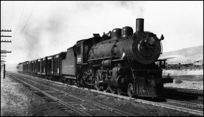 NP 2213, a 4-6-2 Pacific Class Q-4 pulling a mixed passenger train No. 256 and freight train at DeSmet, Montana.