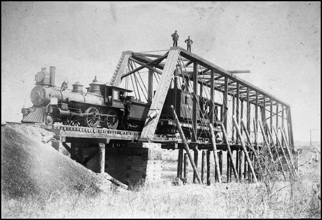 NP 837, a 4-4-0 American Std Class C-11, Former NP 31, with a work crew at Heart River Bridge near Mandan.
