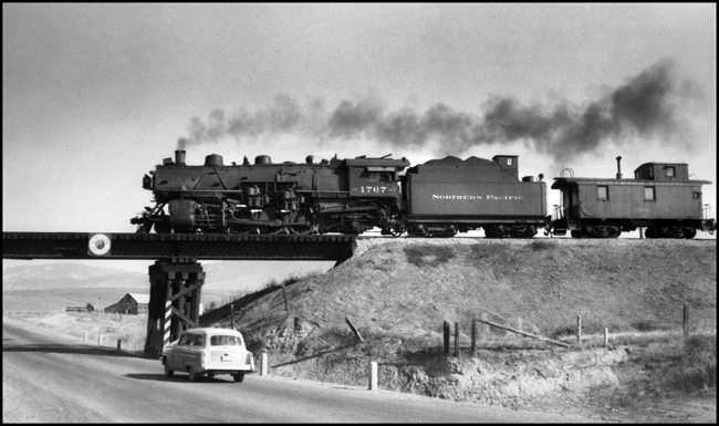 NP 1767, a 2-8-2 Mikado Class W-3 is a west bound extra crossing the bridge west of DeSmet, Montana.