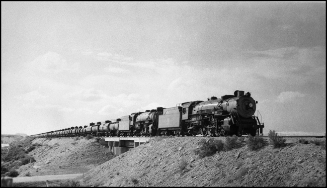 Chicago Burlington & Quincy Railroad 5501 and 5512 double head a tank car train near Boysen, Wyoming.
