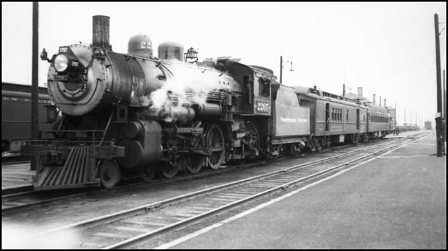 A  Q-4 Pacific is ready to leave spokane for Pullman and Lewiston with a short passenger train.  The engine, is a 1909 product of Baldwin.