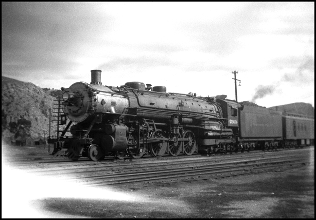 An A 4-8-4 pauses at the junction station at Logan to allow passengers to make connections for alternate routes.  This engine was part of the first order of Northerns built, built at ALCO in 1927.