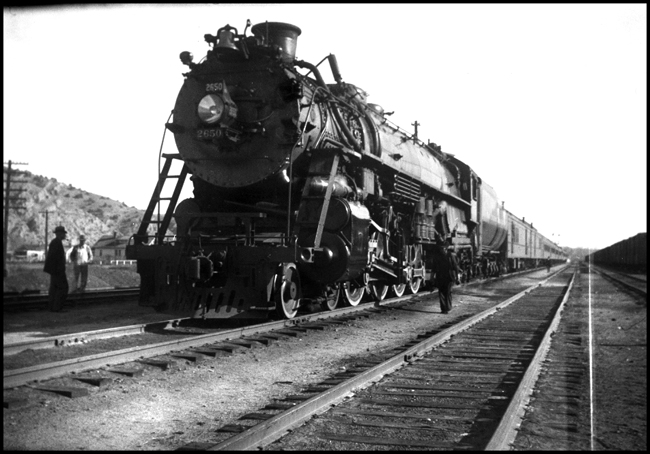 Logan has one of its more exciting moments as the westbound North Coast Limited makes its scheduled pause and transfer connecting passengers to the Helena train.  The power is one of NP's 10 A-2 Northerns, built by Baldwin in 1934.