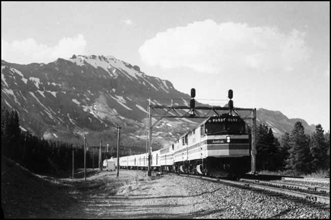The Empire Builder name was continued by Amtrak, and remained a train of quality long after the Great Northern name was painted over.  This is the Builder westbound on the GN main in Montana, led by two P-40 diesels(?) and an old E unit service as an auxiliary fuel tender. 