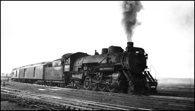 An O-1 Mikado eases some head end cars from Saint Paul Union Depot to the coachyard.  The engine is a 1923 Baldwin, and it will be a part of the Burlington steam fleet until June, 1959.