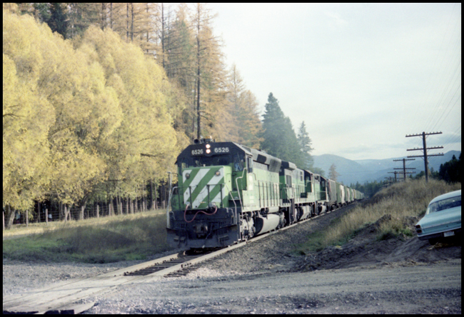 BN X6819W with lead unit BN 6526 approaching grade crossing at Belknap, MT.
