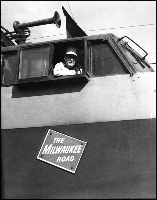 An engineer in his working setting, the cab of a nearly new Little Joe electric on the Milwauklee electrification in Montana.