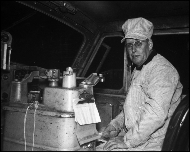 An engineer, seen in his working environment, the right hand seat of a Little Joe electric.
