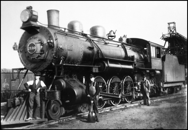 A proud head end crew and their nearly new Q-1 Pacific pose near the coal sdock before setting out on a days work.  The occasion may be a special one, with the fireman wearing a tie and the brakeman dressed for an office job.  The engine is a 1905 ALCO embarking on a 42 year NP career.