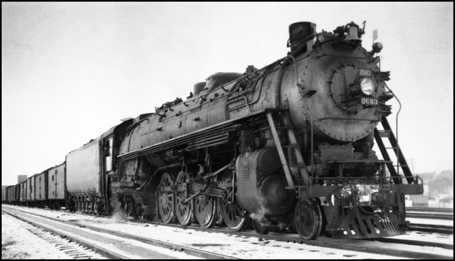 An A-5 Northern in its normal habitat, fast freight service in the Dakotas.  The reefers up front could be meat or fruit, and the direction of the train is not determined.  The engine is a 1943 Baldwin, and is not et three years old.