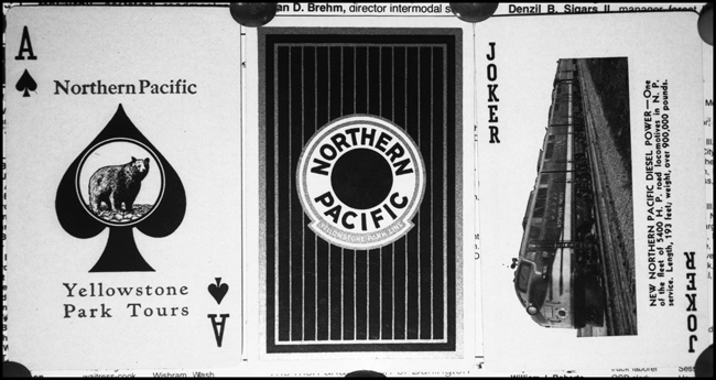 Playing cards were often available for purchase on trains, and trheir availabity was often advertised in public timetables.  And if yo're gonna stock them you may as well get some extra advertising milage out of them.  Here is an examplof of one more way NP conveyed its message.