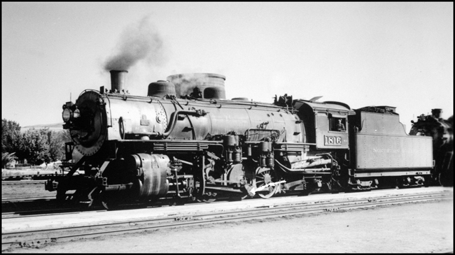 NP 1816, Class W-3 tied to another steam locomotive in Livingston, MT.  Fireman in cab window.