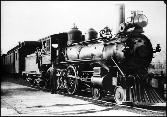 Copy of Photo of NP 700, Class C-3 coupled to a mail car with several workman in and around locomotive.