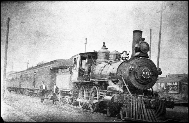 NP 671, Class  B locomotive pulling a passenger train at and unknown station.