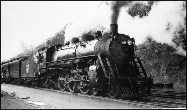 SOO 729 pulling passenger train being loaded with mail and baggage at Osceola, WI