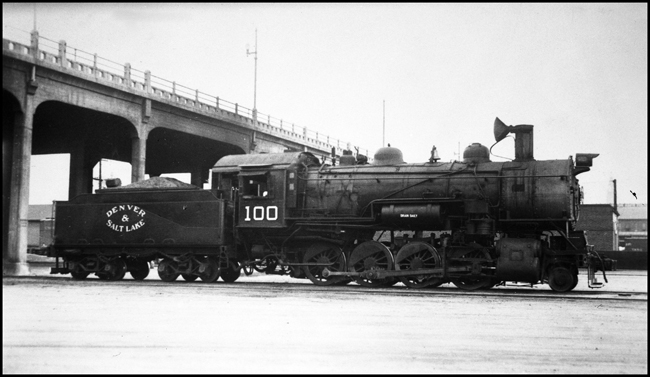 Denver and Salt Lake 100, 2-8-0, under bridge in Denver yards.