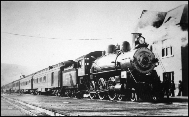 NP 277, Class P steam locomotive stopped at early depot in Livingston with passenger train.  Depot in picture was on the north side of the tracks across the yard from the depot that was used at time of the BN merger.  Passenger train in photo was being serviced.
