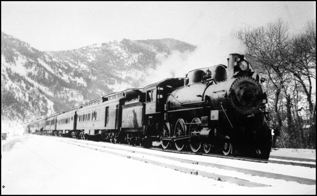 NP 277, Class P steam locomotive on passenger run possibly east of Livingston near Springdale with train stopped and workers working about cars.  Suspect possible freezing problems have developed with heating system.