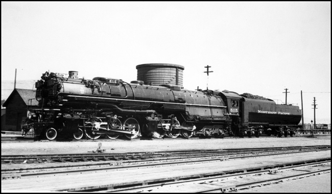 NP 5115, Class Z-6 by section gang shack near underpass in Livingston, MT.