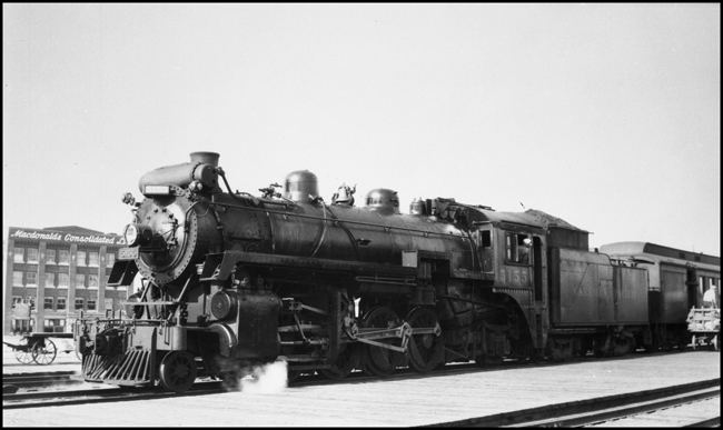 CPR 5155, on NA passenger train which is loading baggage in Edmonton