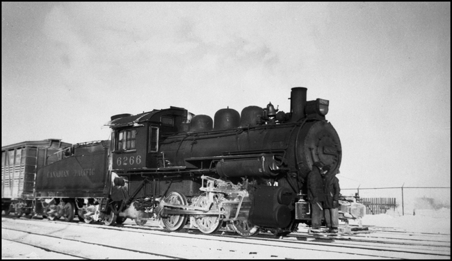CPR  6266, 0-6-0 locomotive with switch crew riding front pilot steps.