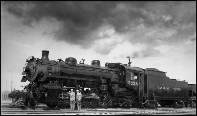 CPR 5236, 2-8-2 receives service attention while on a freight assignment in Winnipeg.