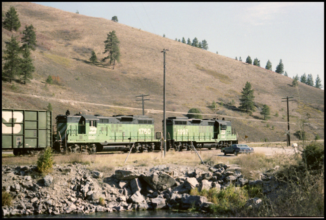 BN X1797-1760E east of Ravalli, MT.  Ron Nixon's automobile parked by tracks.
