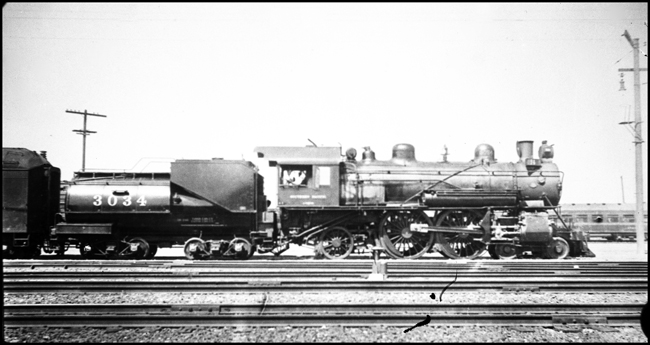 UP 3034, 4-4-2,  steam locomotive on a passenger run at an unnamed location.