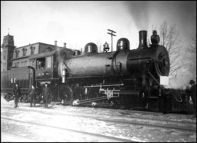 NP 41, Class Y in front of Brainerd Depot, with crew members standing around engine.  Engine is brand new.  