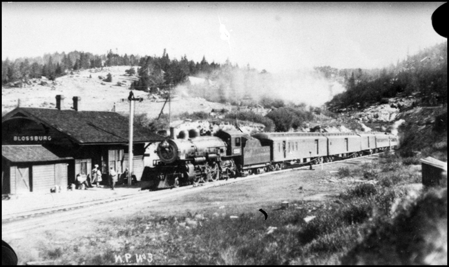 NP Train No.3, with NP 2223, Class Q-3 at Blossburg with passengers waiting for the train.