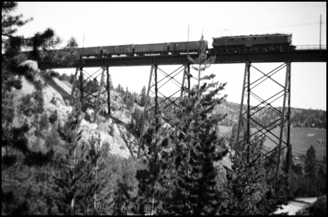 MILW 10307 electric locomotive on trestle near west Donald, highest point on Milwaukee route west.