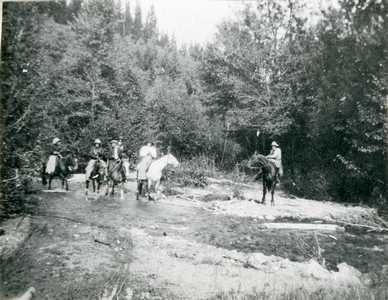 Horseback Riders Crossing a Shallow Stream