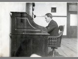 Alfred Atkinson Seated at Roll Top Desk
