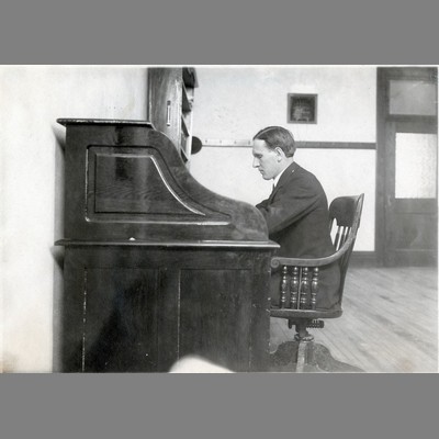Alfred Atkinson Seated at Roll Top Desk