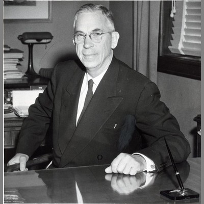 A. L. Strand Sitting at Desk