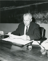 Roland R. Renne At His Desk, c. 1960