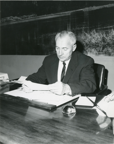 Roland R. Renne At His Desk, c. 1960