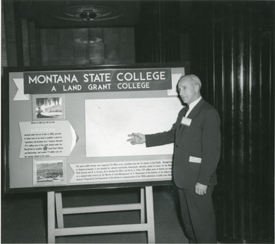 Roland R. Renne With Poster