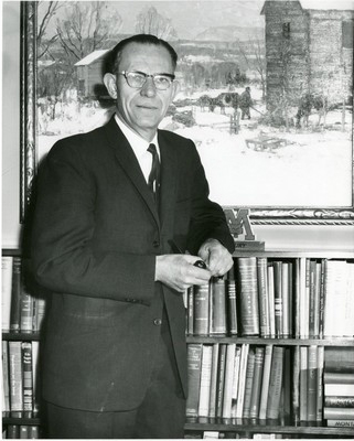 Leon H. Johnson with Painting and Bookcase