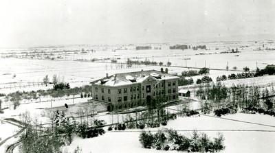 Montana State College Agricultural Building with greenhouses attached in the snow.