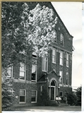 Students sitting in front of the entrance to Lewis Hall