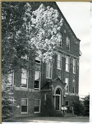 Students sitting in front of the entrance to Lewis Hall