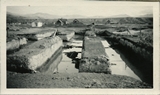 Dirt piles and water in excavation area for the construction of Roberts Hall, 1921