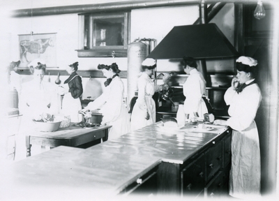 Women work on their cooking skills in a Domestic Science class, 1905