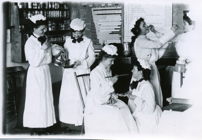 Women pose for a photo in a Domestic Science class, 1905