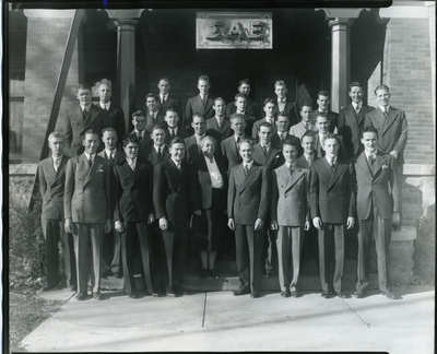 Sigma Alpha Epsilon members posing in front of SAE house, 1940