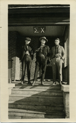 Sigma Chi members "Torchy" Swan and Lorren Bradford on porch of house, 1921